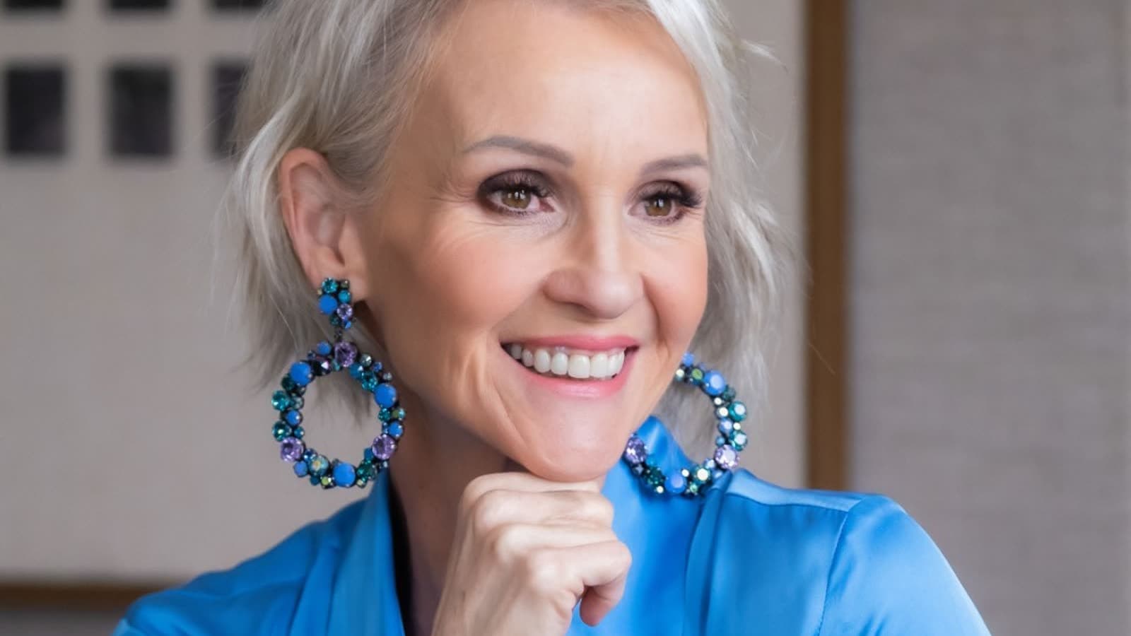 Linda Paige close-up in navy silk with statement earrings, Executive Coach and Stylist