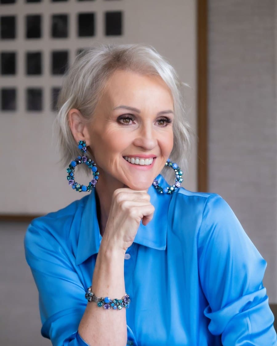 Linda Paige close-up in navy silk with statement earrings, Executive Coach and Stylist