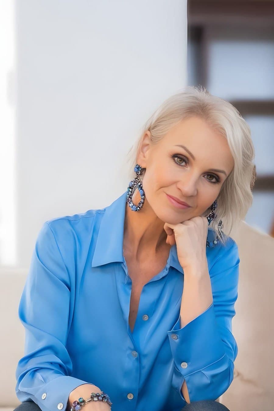 Linda Paige in peach satin, hand on cheek, your next strategy call is waiting