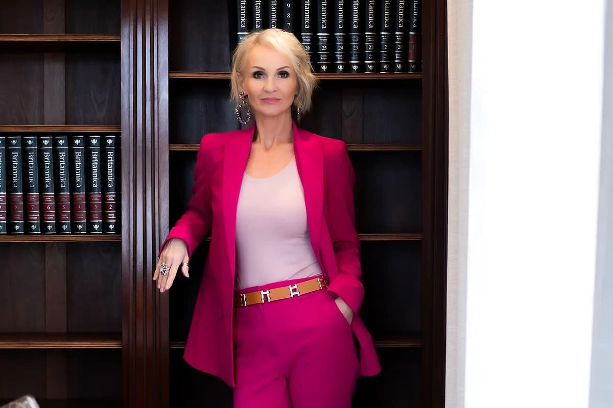 Linda Paige in a ruby blazer, full-length portrait — Dauntless 1-on-1 executive coaching