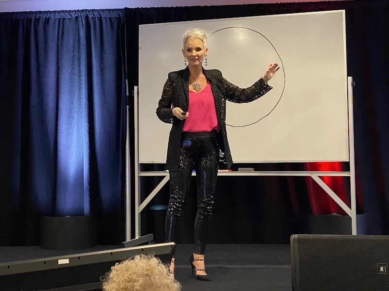 Linda Paige teaching at the whiteboard, the curated training vault